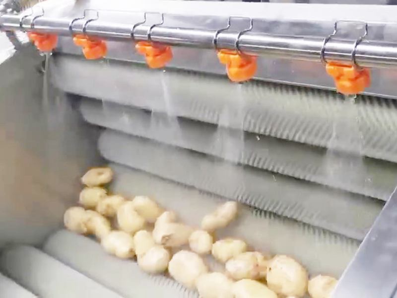 water spraying from nozzles of brush washing machine